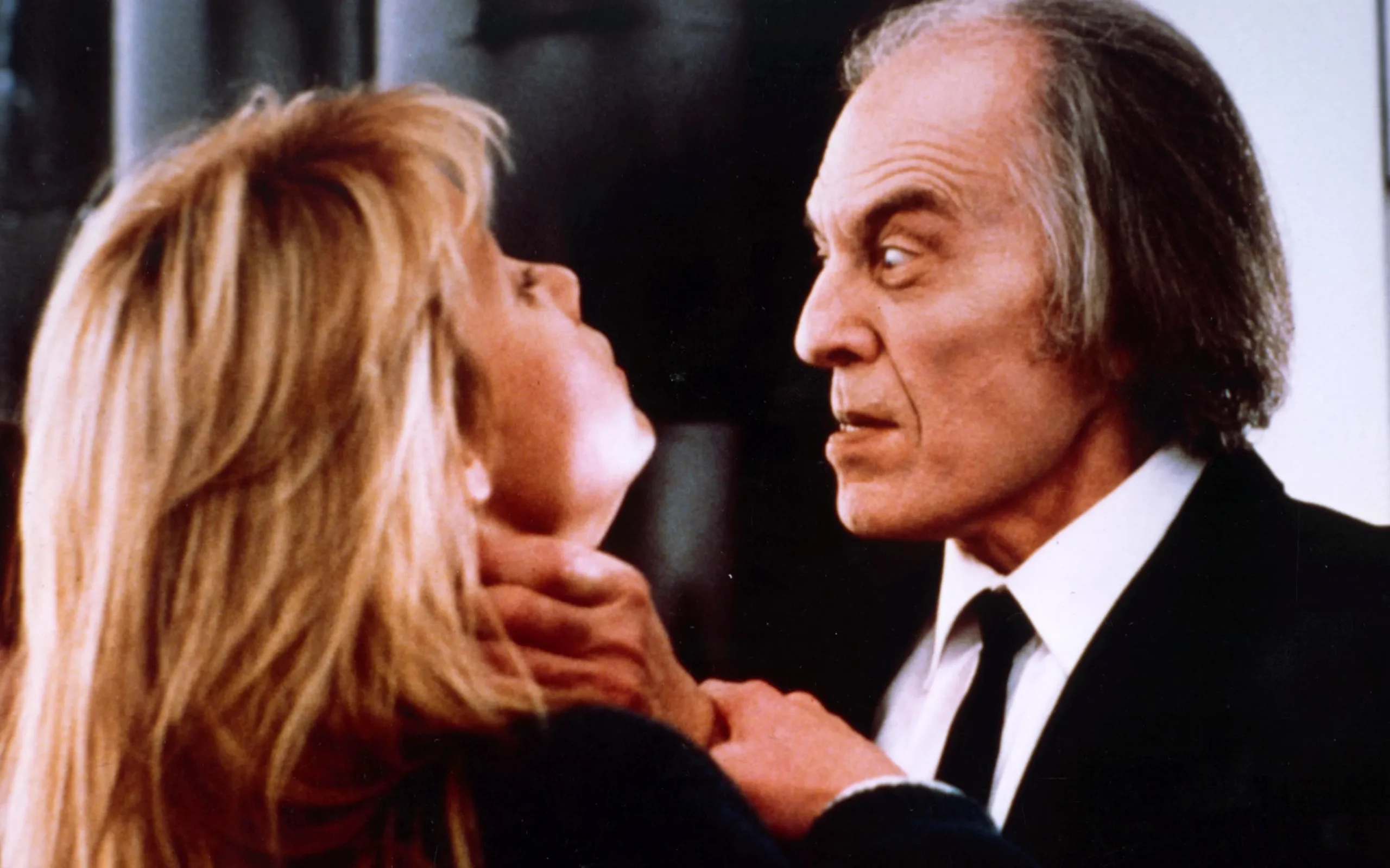 Phantasm-4 | film.org.pl Man in a dark suit leans in toward a blonde woman as they share a close, intimate moment in a dance-like embrace.