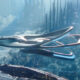 Futuristic silver spaceship gliding between towering glass skyscrapers above a cloudy blue cityscape. ɪn culprits