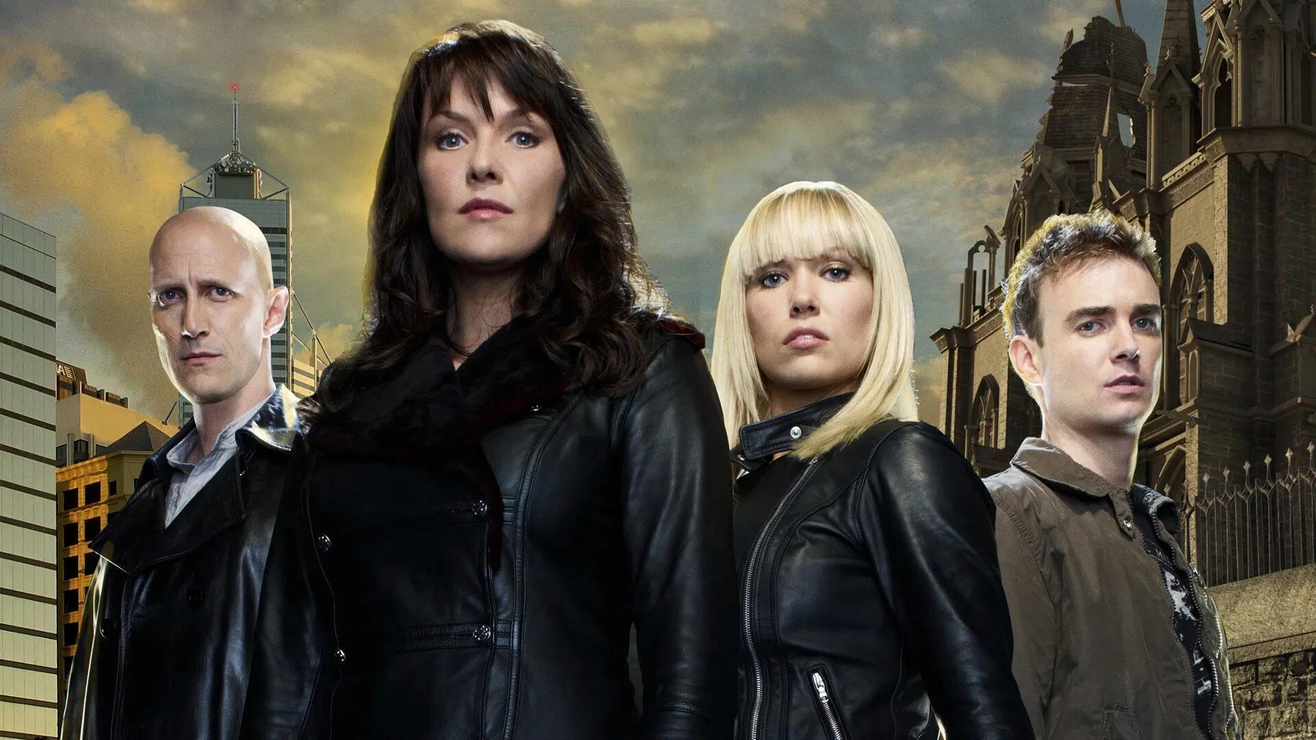 sanctuary-2 | film.org.pl Four adults in leather jackets stand together against a city skyline with a historic church on the right.