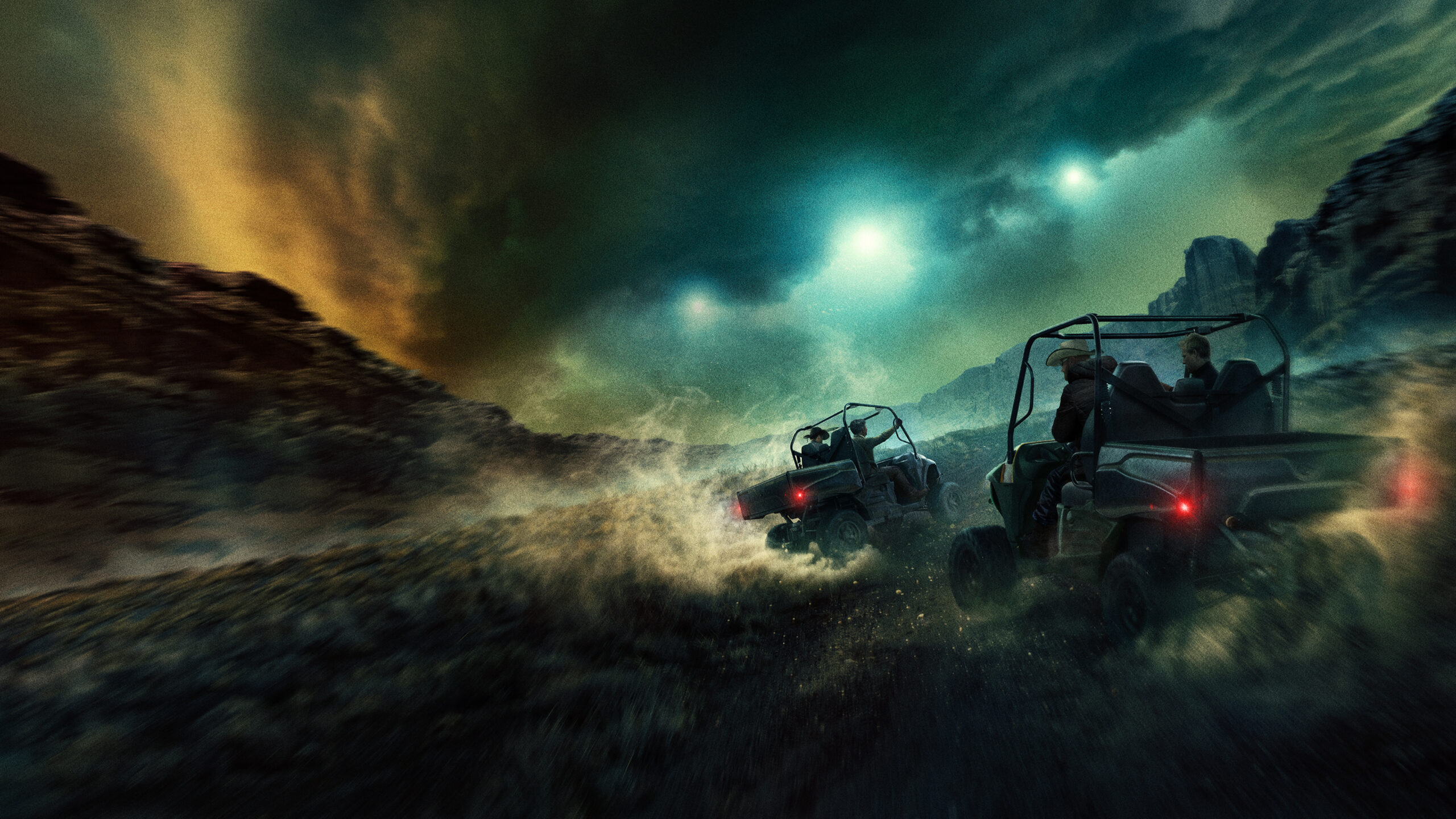 Group of people riding all-terrain vehicles through a smoky, stormy night landscape with rocky terrain and dramatic greenish-blue skies, headlights glowing.