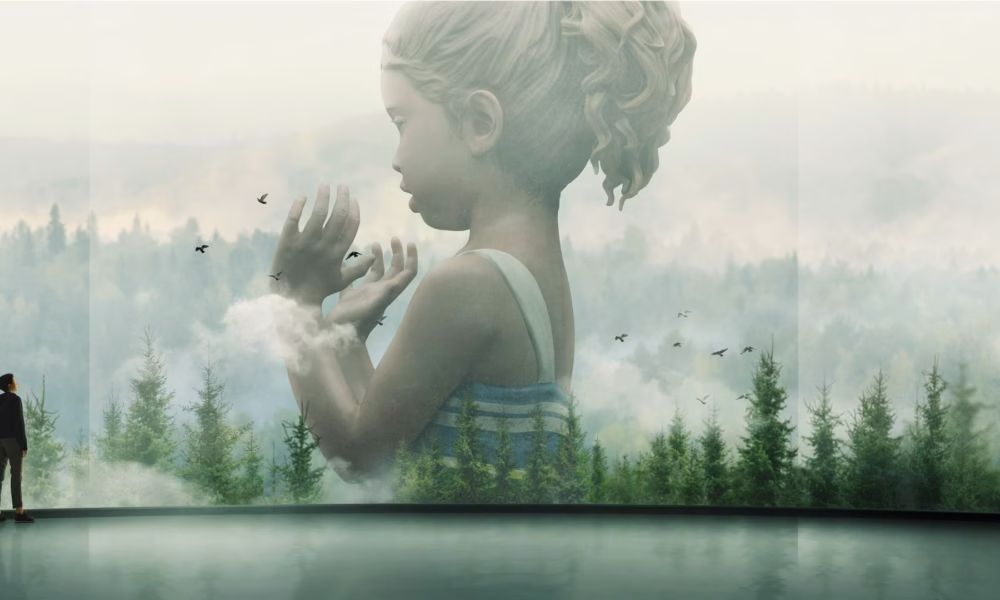 Man standing in a gallery viewing a large double-exposure mural: a girl’s semi-transparent profile blending into a forest landscape.