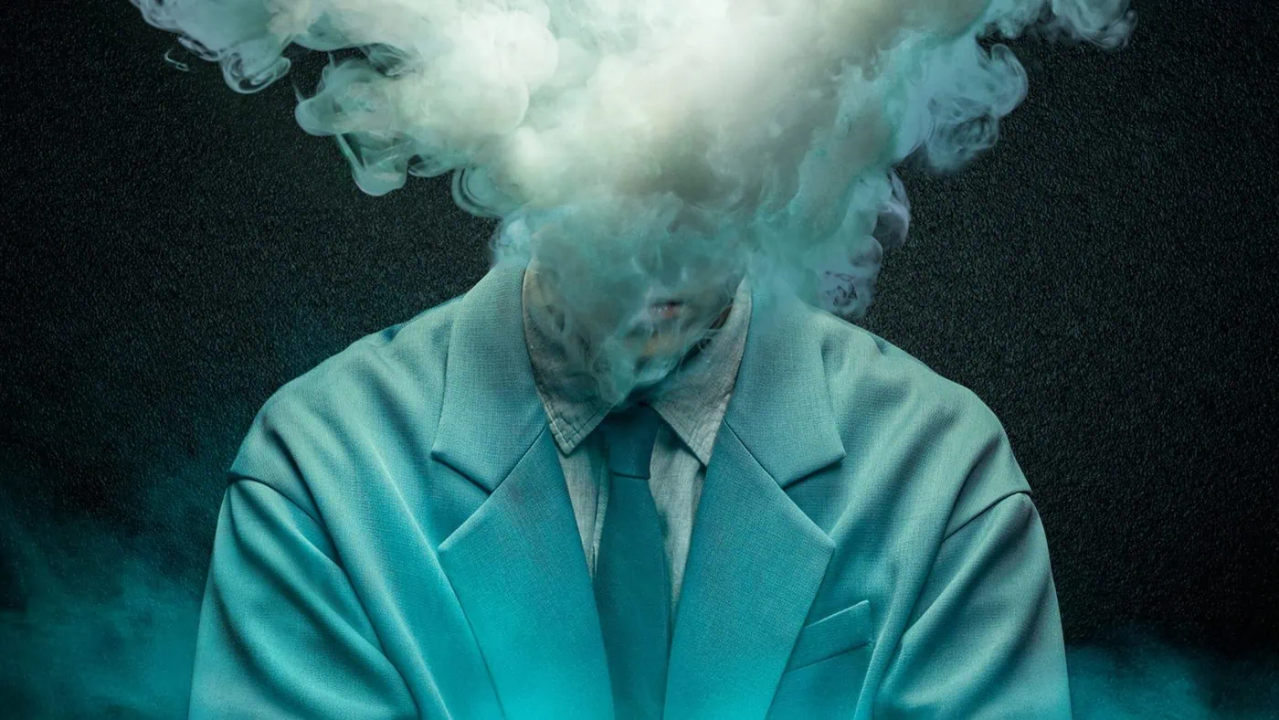 Person wearing a teal suit with smoke obscuring their head, creating a surreal portrait.