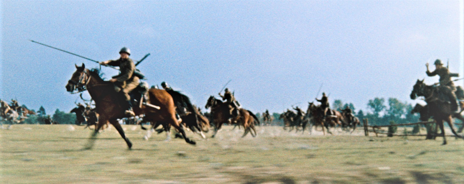 Cavalry charge across an open field with riders on galloping horses and lances raised