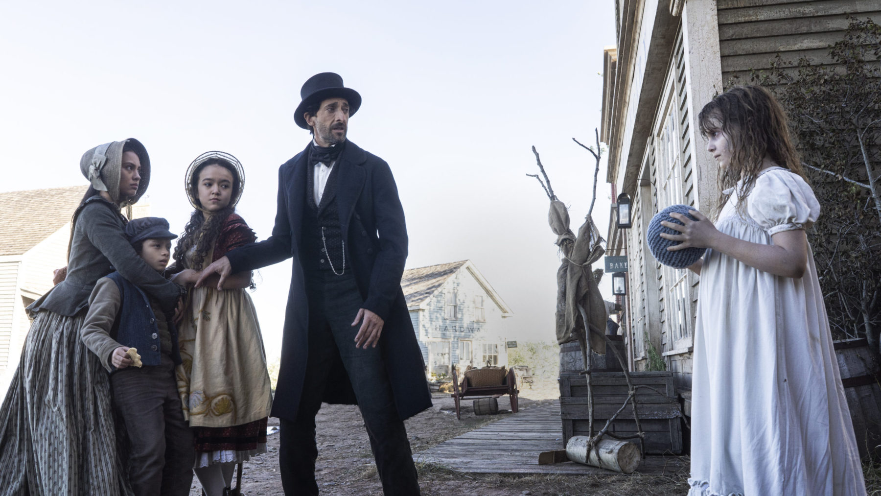 Chapelwaite Season 1 Episode 101 Pilot | film.org.pl A man in a top hat and dark suit stands with children in 19th‑century clothing on a dusty street.