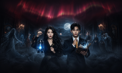 Two central figures—a woman with a blue lantern and a man with a glowing book—stand in a foggy, moonlit haunted room surrounded by ghostly figures.