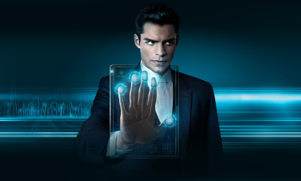Businessman in a dark suit extends his hand toward a glowing blue holographic touchscreen.