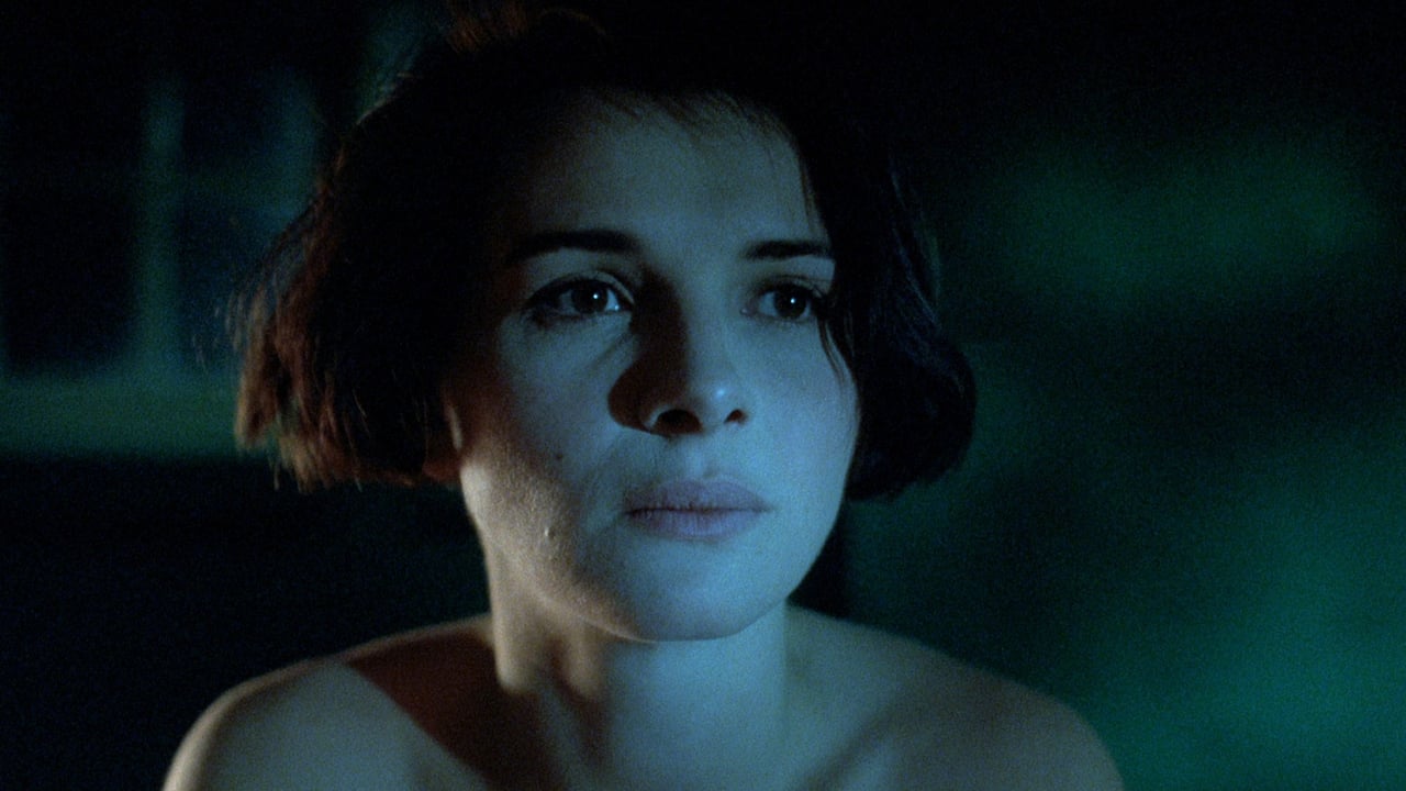 trzy-kolory-niebieski | film.org.pl Close-up of a woman in blue night lighting, looking pensively off-camera, bare shoulders visible.