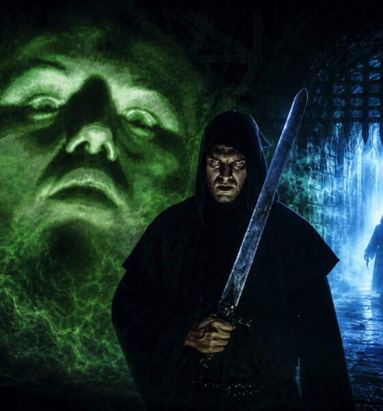 Hooded warrior with a large sword stands in a damp dungeon, green spectral face behind him and a blue-lit gate to the right.