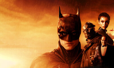 Poster for a Batman movie featuring Batman in the foreground with a team of allies against an orange, burning city backdrop.