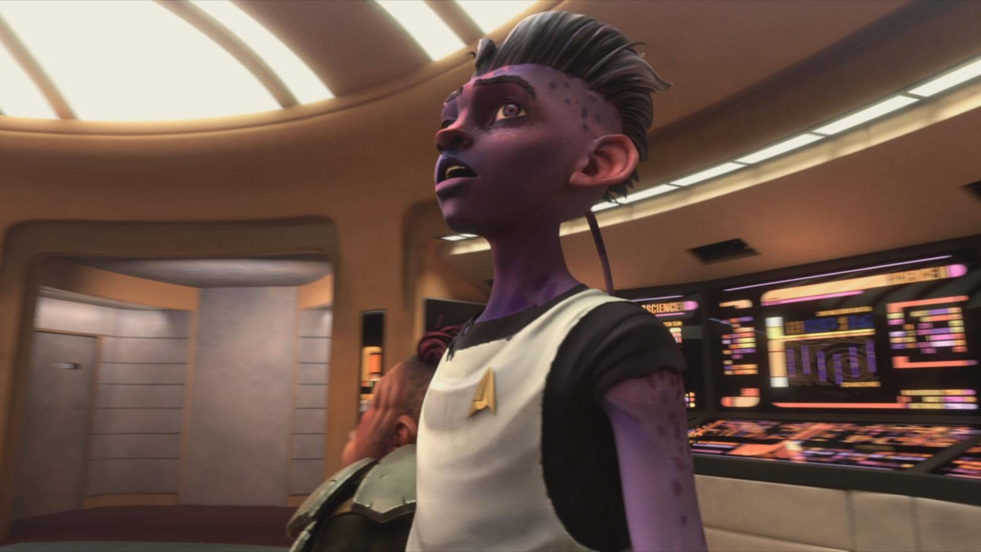 Kadr z serialu Star Trek: Protogwiazda: animowana postać o fioletowej skórze w białym mundurze z złotą odznaką w futurystycznym wnętrzu.